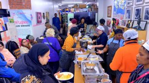 Community members being served food at a community cooking show event