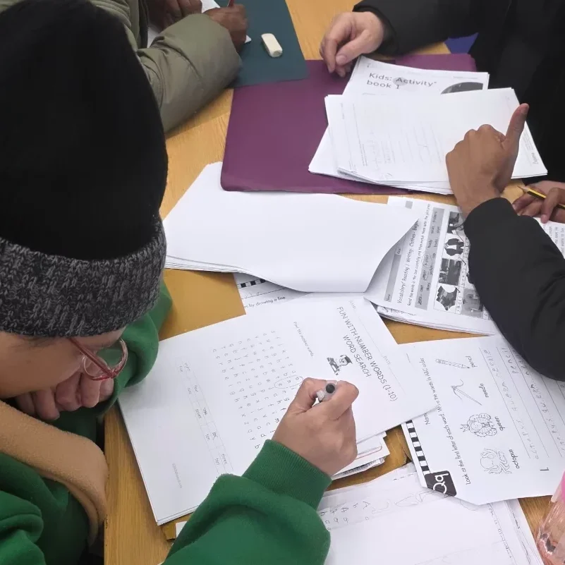 Participant engaged in writing during Creative Connection community engagement session at CAS