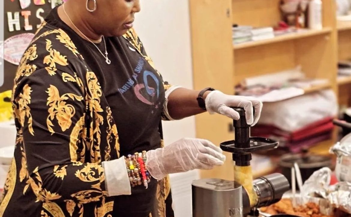 CAS CEO participating in a cooking activity at a community cooking show