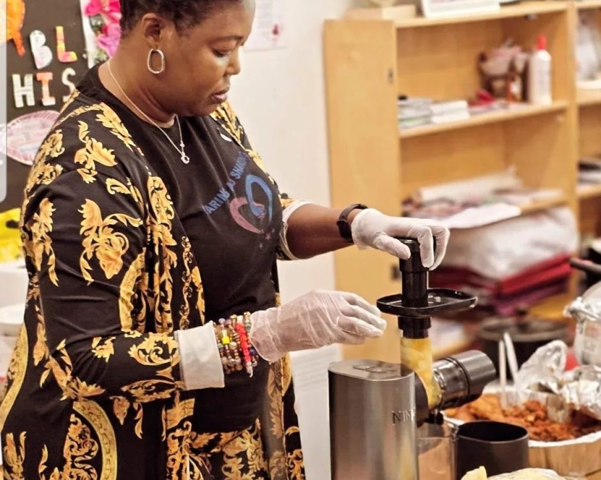 CAS CEO participating in a cooking activity at a community cooking show