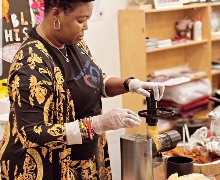 CAS CEO participating in a cooking activity at a community cooking show