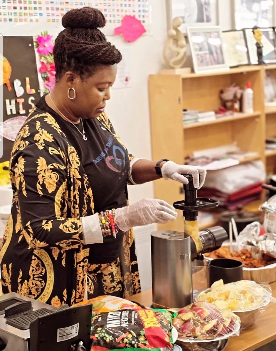 CAS CEO participating in a cooking activity at a community cooking show
