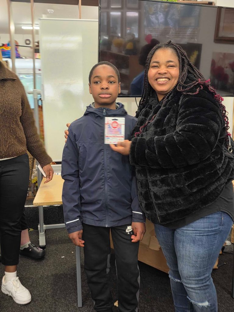 Winners of creative arts competition receiving vouchers at CAS Easter Holiday Activities Programme