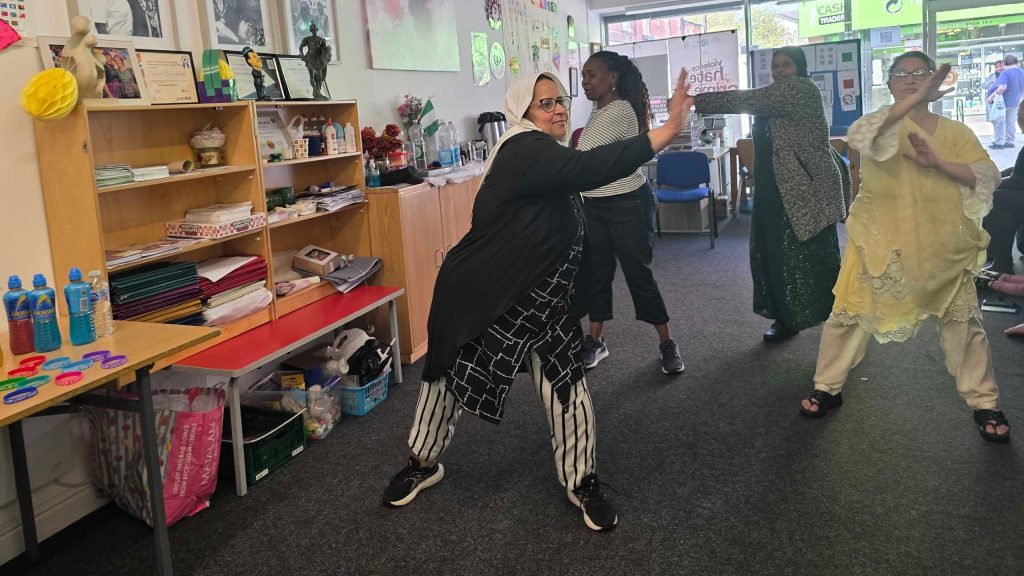 Inclusive community fitness activity with participants engaging in guided movement exercises during a CAS wellbeing session