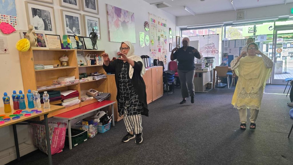 Community members participating in a group exercise session promoting wellbeing and physical activity in a supportive environment