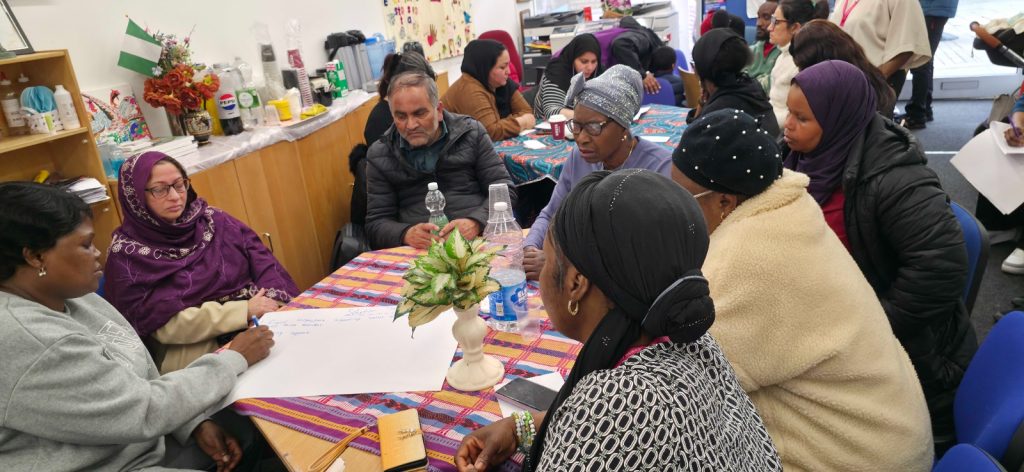 Community members during Humanity Project Assembly One in Rochdale discussing housing insecurity and homelessness support