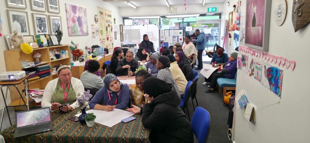 Participants engaging in community discussions on homelessness awareness and housing challenges in Rochdale.