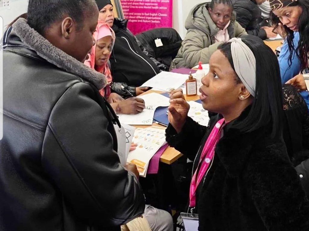 Community participant engaged in a discussion with a CAS facilitator during a support and engagement session