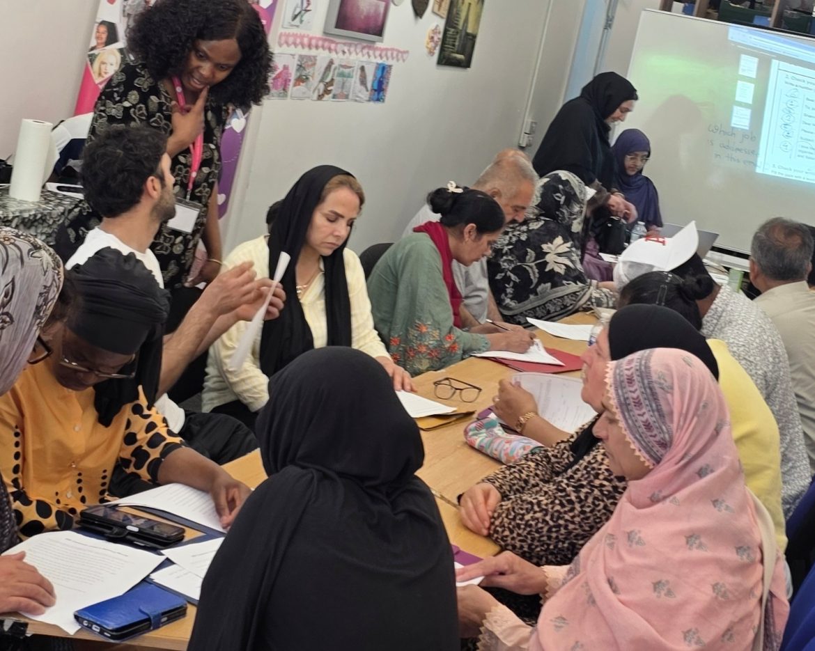 Featured image of ESOL learners taking part in a class at Caring and Sharing Rochdale.