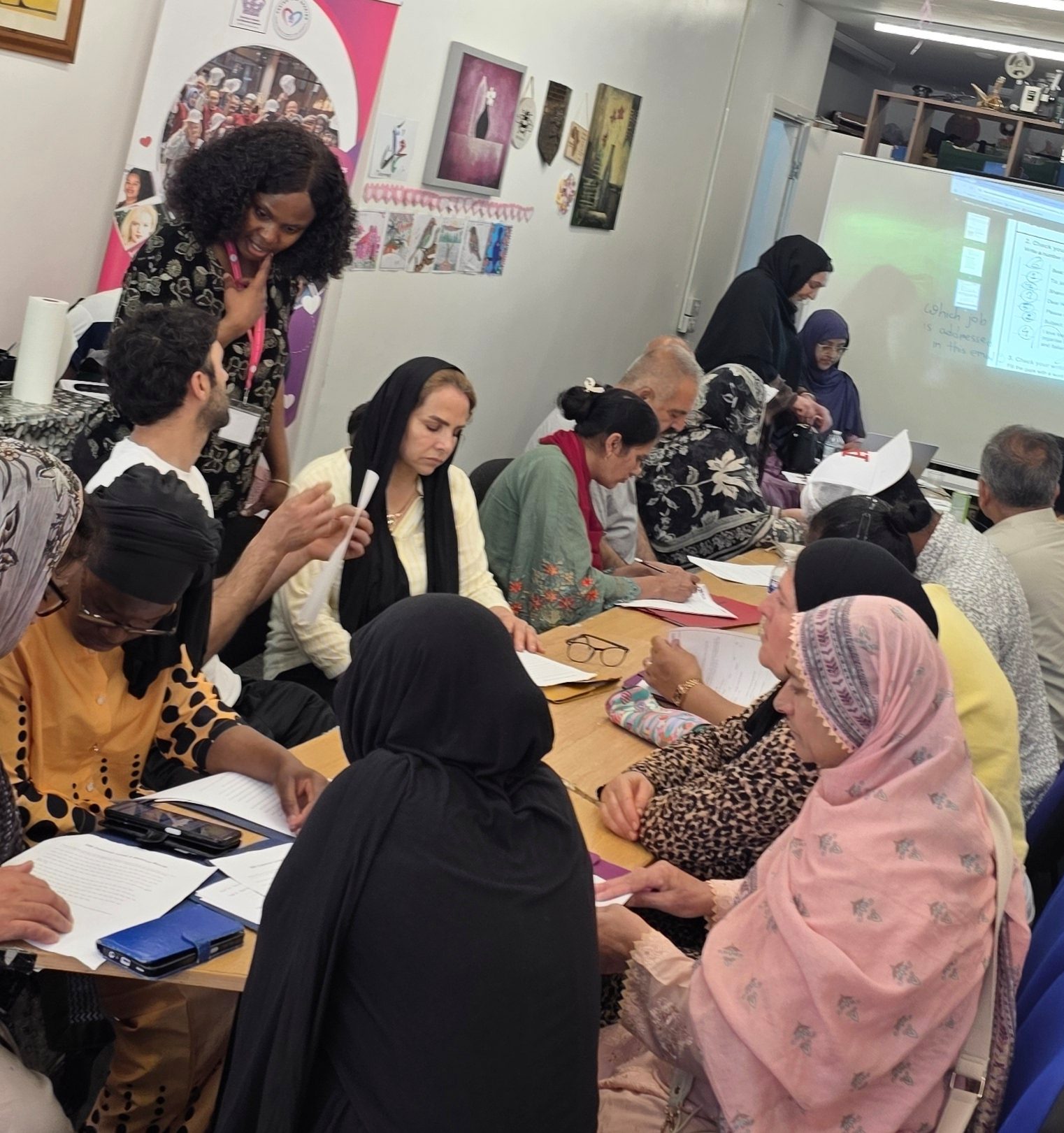 Featured image of ESOL learners taking part in a class at Caring and Sharing Rochdale.
