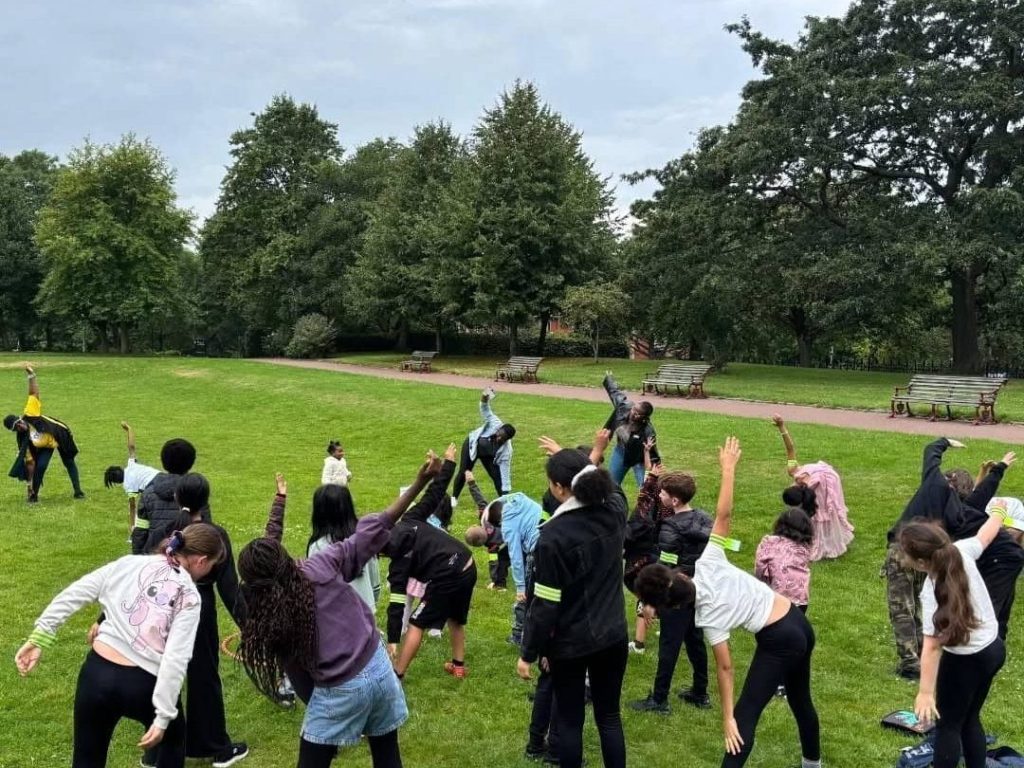 Children enjoying an outdoor adventure during Caring and Sharing Rochdale's Summer Holiday Activities programme.