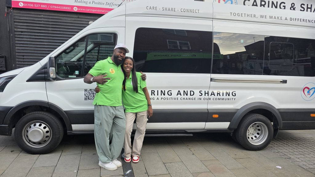 CAS staff standing beside the new community minibus