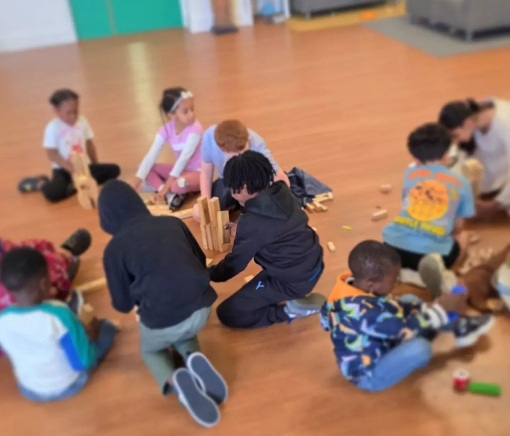 Children working together on a brick-building activity during HAF 2026