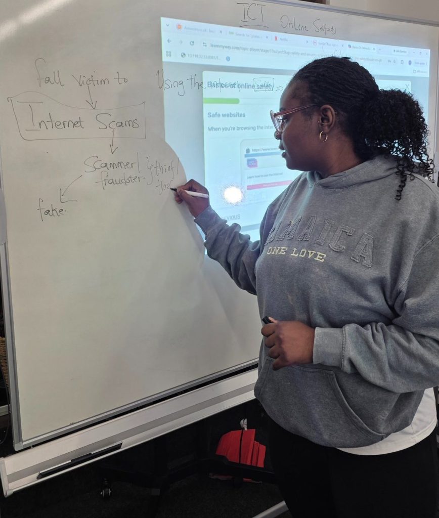 ICT facilitator in a digital literacy session at Caring and Sharing Organisation.